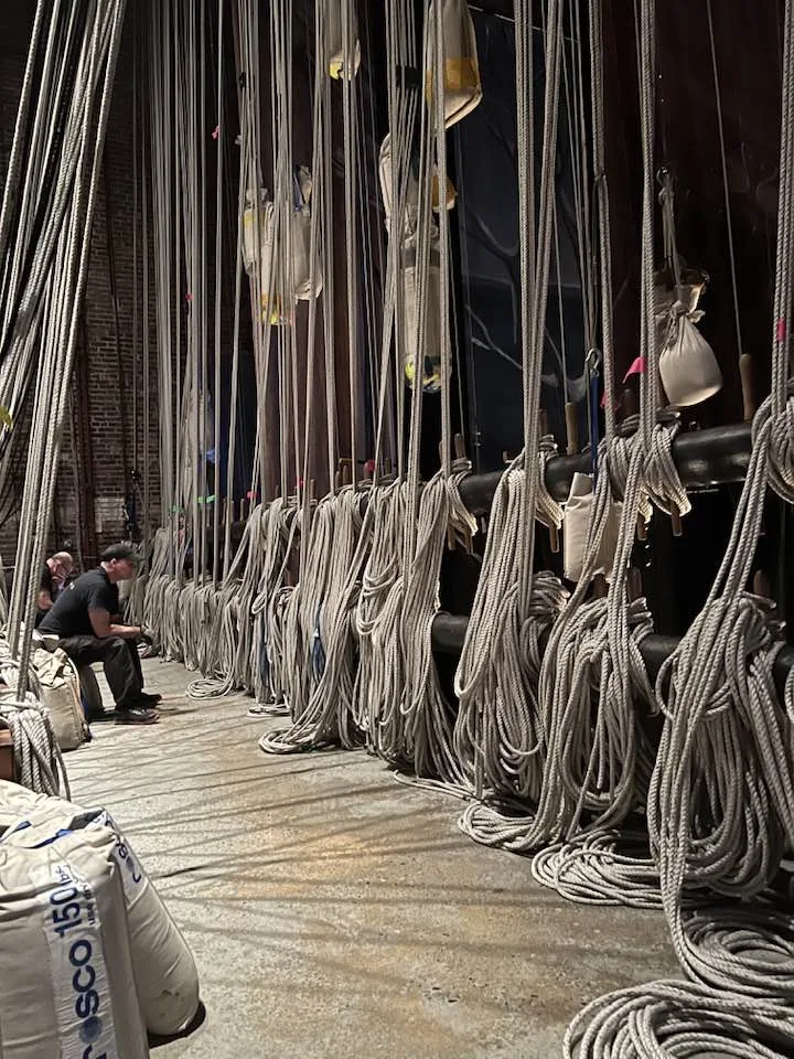 Coiled hemp lines and sandbags at the fly rail of a traditional counterweight fly tower